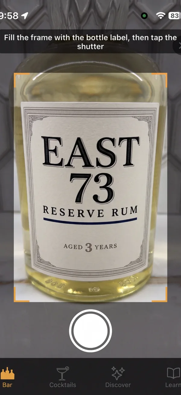 Expressed bottle scanner framing a rum label, with the prompt to fill the frame with the label and tap the shutter